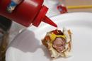 Veronica Raygoza prepares her tiny hot dog lunch two months after gastric bypass surgery at her home in Denver