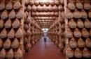 File photo of a worker walking in a special room where Parma ham are hung to dry in Langhirano