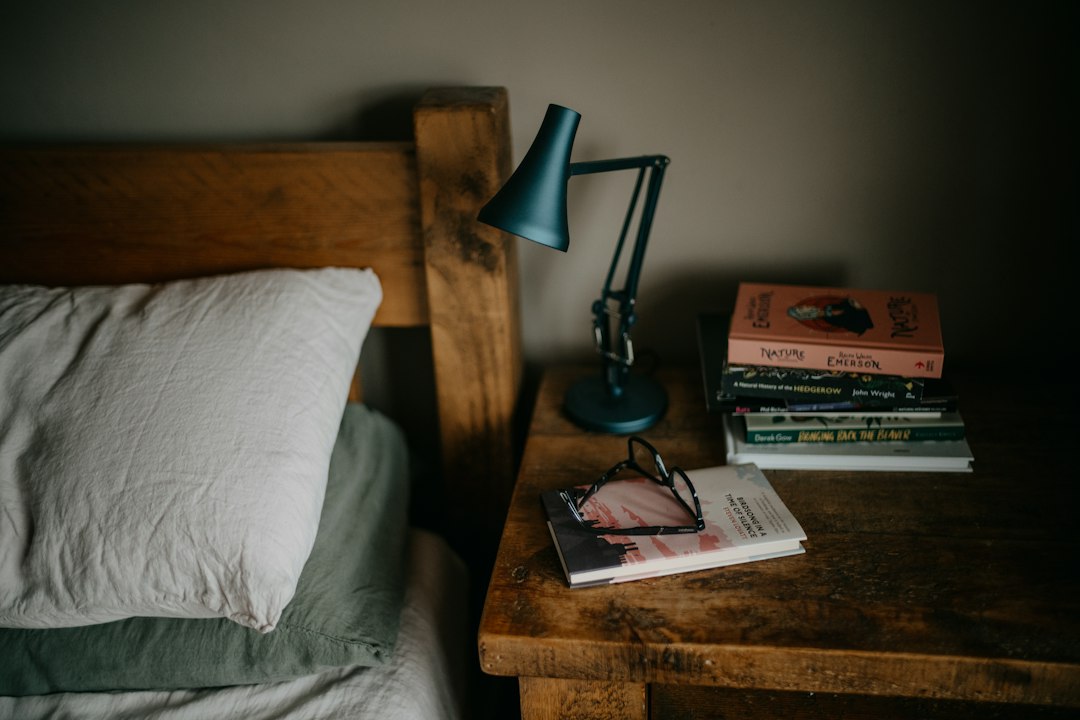 Books and bedside lamp representing a simple evening symptom log