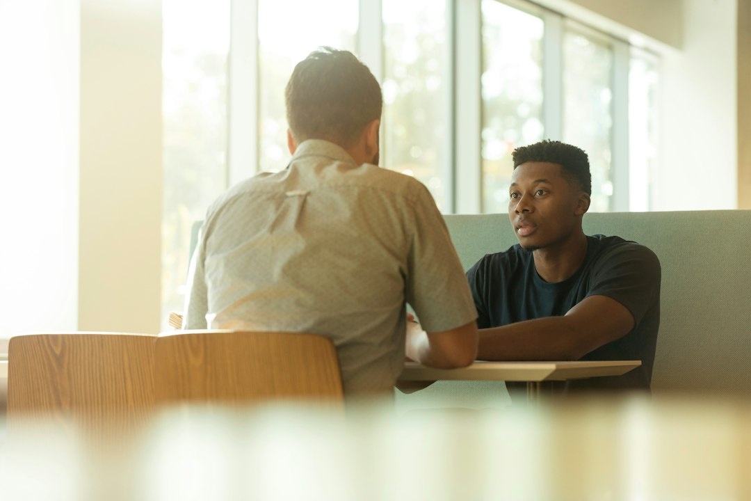 Two adults discussing the main concern for a pain-management visit